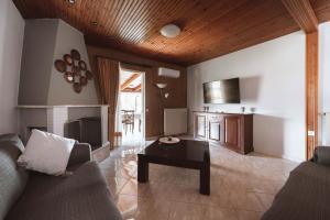 a living room with a couch and a table at Stella's Holiday Resort in Tigaki