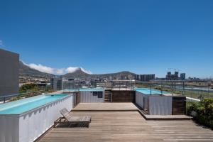 a swimming pool on the roof of a building at Modern Two Bedroom Unit, Mountain & Harbour Views in Cape Town