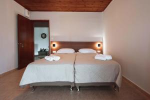 a bedroom with a large bed with two towels on it at Stella's Holiday Resort in Tigaki