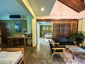 een woonkamer met een bank en een tafel bij T-House BKK 2Floors near BTS with swimming pool and free Wifi in Klong Toi