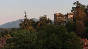 a castle on top of a hill with trees at Hotel La Villa in Ceccano