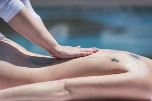 a woman with a tattoo on her back in a swimming pool at Magnifique villa avec piscine au bord de mer in Chorafakia