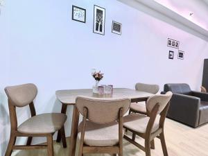 a dining room with a table and chairs at Pavilion 2 Revol Sky Pool 2-3 pax LS25 in Kuala Lumpur