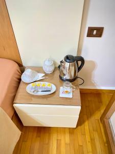 a table with a tea kettle on top of a bed at Golden house - men only in 6th Of October