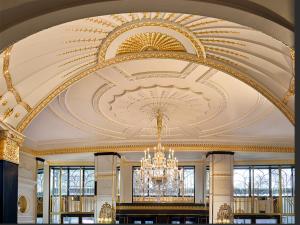 a large room with a ceiling with a chandelier at The Dorchester - Dorchester Collection in London