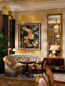 a living room with a couch and a painting at The Dorchester - Dorchester Collection in London