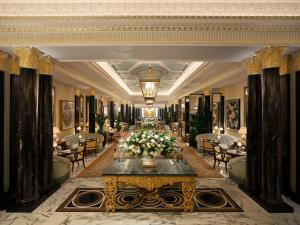 a hotel lobby with a table with flowers on it at The Dorchester - Dorchester Collection in London