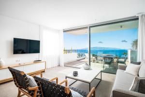 a living room with a view of the ocean at Los Jardines de Abama Suites in Guía de Isora