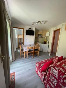 a living room with a couch and a dining room table at Thollon-Les-Mémises - IGLOO 2 in Thollon