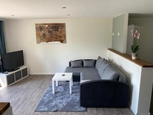 a living room with a couch and a table at Ferienwohnung Maldener in Namborn