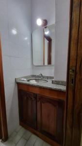 a bathroom with a sink and a mirror at Apart Hotel Santa Lucia in Mar del Plata +37 photos