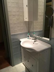 a bathroom with a white sink and a mirror at WI-FI Clima Molfetta 26 in Rome