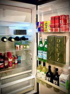 an open refrigerator filled with lots of drinks and drinks at Le Secret de Mélin in Mélin
