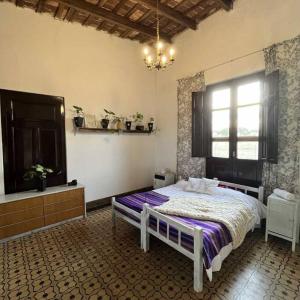 a bedroom with a bed in a room with a window at Uruguay Casa de Época Campestre in Mercedes