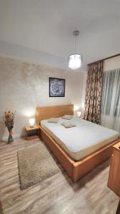 a bedroom with a large bed in a room at Belle Sea View Apartment Mamaia in Mamaia