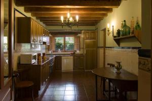 a kitchen with a table and a dining room at El Molino in Nieva