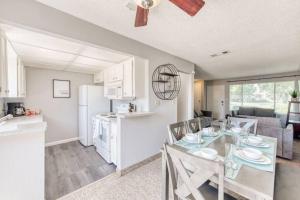 a kitchen and dining room with a glass table and chairs at Lovely 2 bedroom condo in quiet location in Fresno