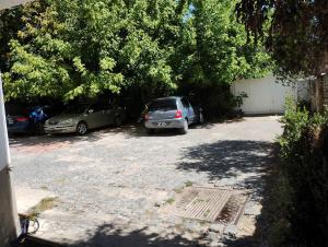 two cars parked in a driveway next to a building at Departamentos Centro Dpto 2 1 habitacion in Tandil