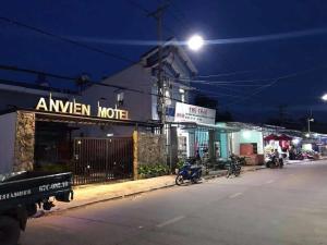 a street at night with motorcycles parked in front of a building at ANVIEN MOTEL in Phu Quoc