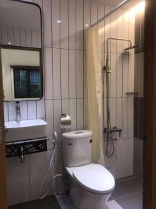 a bathroom with a toilet and a sink and a mirror at ANVIEN MOTEL in Phu Quoc