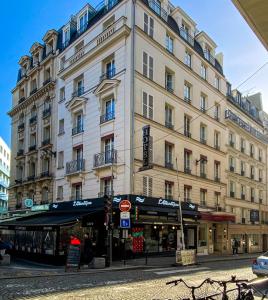 a large building on the corner of a street at Austin's Saint Lazare Hotel in Paris