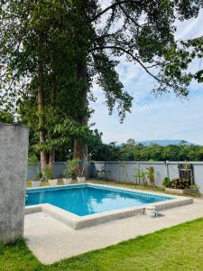 a swimming pool in the backyard of a house at Khanom Garden Suite in Khanom