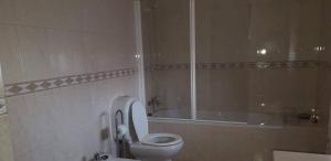 a bathroom with a toilet and a bath tub at Casa da Cândida in Nazaré +8 photos