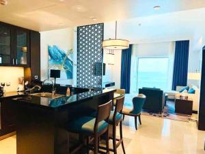 a kitchen and living room with a bar and chairs at home in Abu Dhabi