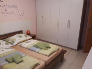 two twin beds in a room with white cabinets at Landhaus Jasmin - Apartment Untergeschoß in Bad Mitterndorf