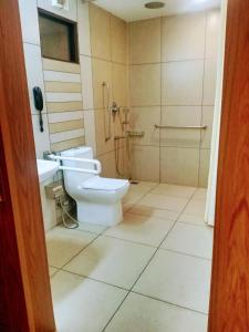 ein Bad mit einem WC und einer Dusche in der Unterkunft Pearlspot Hotel in Kumarakom