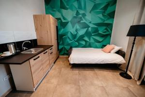 a small room with a bed and a sink at Cukrownia in Opole Lubelskie