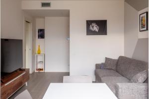 sala de estar con sofá y TV en BnButler - Flavio Gioia, 5 - Appartamento con Vista, Citylife en Milán