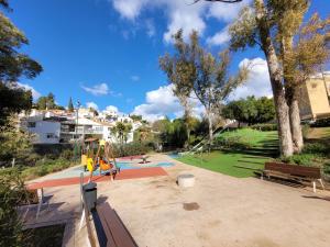 a park with a playground with a playground at "COZY LOFT", TERRACE, PARKING and SWIMMING POOL in Málaga