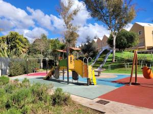 a playground with a slide in a park at "COZY LOFT", TERRACE, PARKING and SWIMMING POOL in Málaga