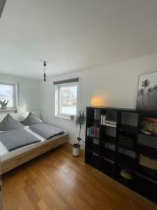 a bedroom with a large bed and a book shelf at Apartment AusZeit - Natur Pur - mitten im Grünen 