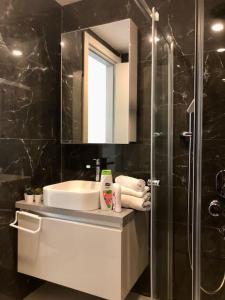 a bathroom with a sink and a shower at Secured Lux 1 + 1 apartment - Gym, Sauna & Parking ( EMP 142 ) in Esenyurt