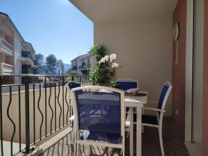 un balcon avec une table et des chaises sur un balcon dans l'établissement Le Romarin - Climatisation piscine & parking privé, à Gréoux-les-Bains