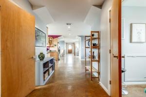 a hallway of a home with white walls and a wooden door at Walk Score 90!!-Historic Downtown District-2 Blocks to Famous Forsyth Park- Huge Private Patio-Private Parking in Savannah