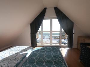 um quarto com uma cama e uma grande janela em Hiša v mesečini - Moonlight house em Cerklje na Gorenjskem