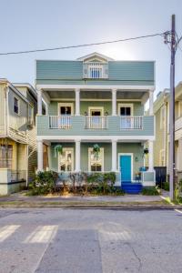 a green house with a blue door on a street at Walk Score 90!!-Historic Downtown District-2 Blocks to Famous Forsyth Park- Huge Private Patio-Private Parking in Savannah