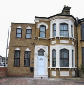 an old brick house with a white door at AJB INTERNATIONAL LTD in London