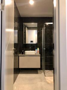a bathroom with a sink and a mirror and a shower at Secured Lux 1 + 1 apartment - Gym, Sauna & Parking ( EMP 193 ) in Esenyurt