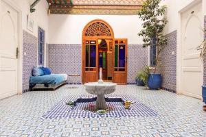 ein Zimmer mit einem Brunnen vor einer Tür in der Unterkunft Riad Hôtel Essaouira in Marrakesch