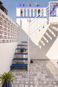 a stairway with blue and white stairs next to a building at Riad Hôtel Essaouira in Marrakesh