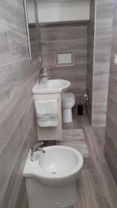 a bathroom with a white sink and a toilet at CASA DELLE PEONIE in Ruffano