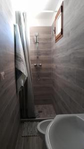 a bathroom with a white tub and a shower at CASA DELLE PEONIE in Ruffano