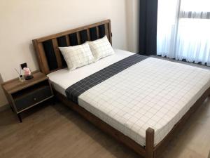 a bedroom with a large bed with a wooden headboard at Luxury Flat, Amazing city view. Gym & Parking ( EMP 271 ) in Esenyurt