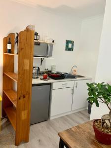 a kitchen with white cabinets and a counter top at Kindred Spirit Guest Suites with solar power in Knysna