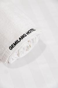 a white pillow with a black inscription on it at Gemilang Hotel in Kota Kinabalu