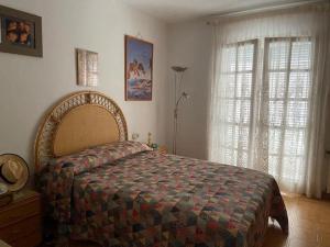 a bedroom with a large bed and a window at Villa Òdena in Odena